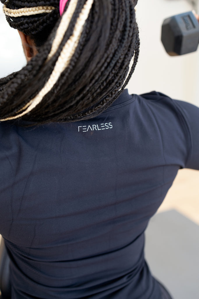 Rear side of the Fearless long sleeve gym shirt in black, with the reflective silver FEARLESS logo.